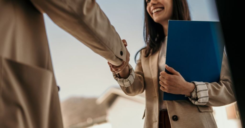 A man shaking a woman's hand.