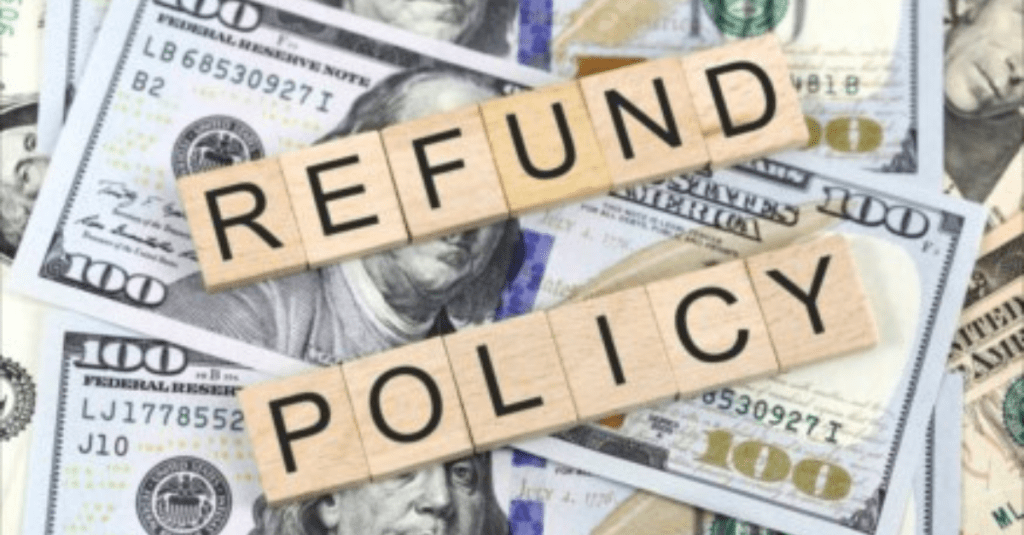 A pile of cash with scrabble letter tiles on top spelling out Refund Policy