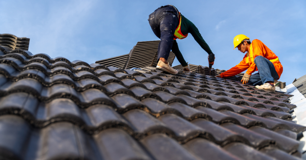 Two construction workers working on a roof