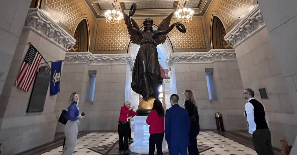 Big I CT members on tour at the Connecticut State Capitol Building in front front of the Genius of Connecticut Statue