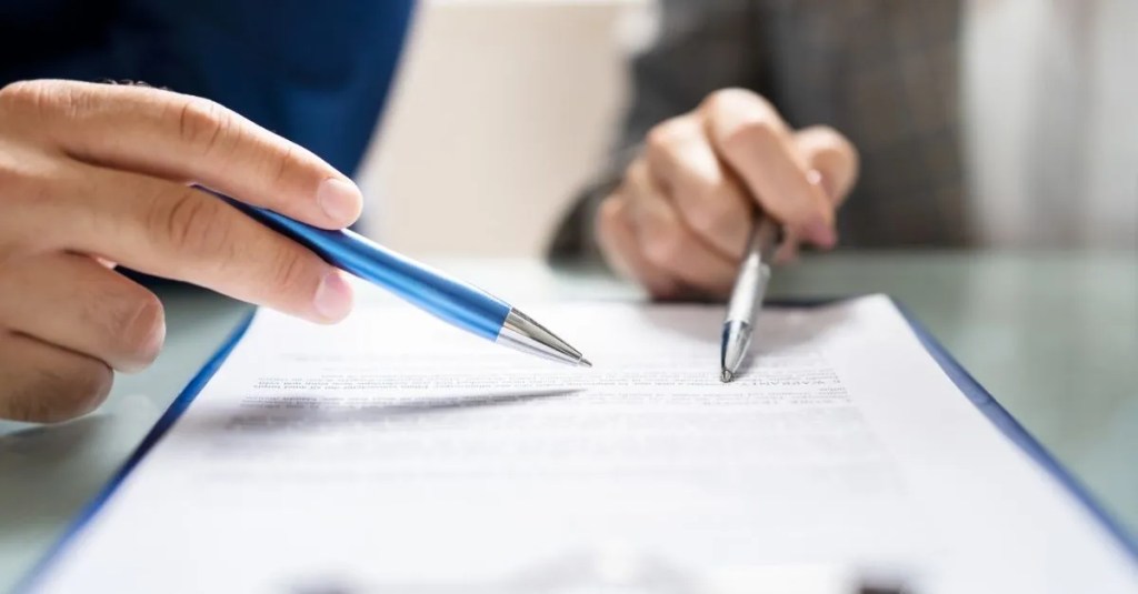 Two people reviewing a document.