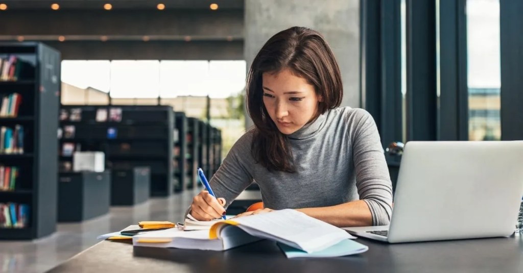 A woman studying in library.