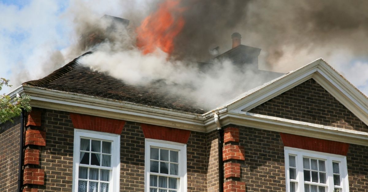 Smoke coming from the roof of a house fire.