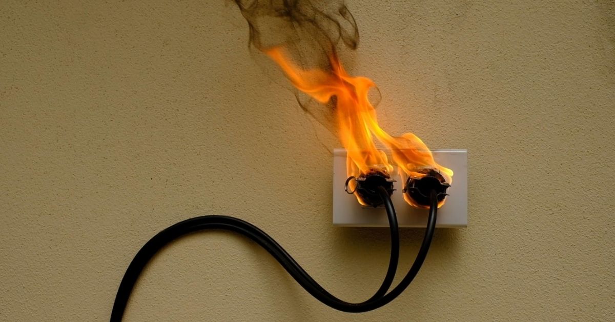 Wall outlet with electric wire plugged in caught on fire.